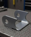 Heavy Duty Swing Arm Bracket And Control Arm Bracket Shock Absorber Mount Kit For Custom Off Road Builds With Robust Steel Fabrication Hardware showing a close-up of steel bracket on workbench.