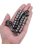 Hand holding 20 Pack 608 2RS Ball Bearings 8x22x7mm Double Rubber Sealed Pre Lubricated C3 for 3D printers, roller skates, scooters.