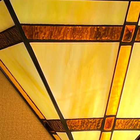 Close-up of Tiffany Style 12 Inch Wide Wall Sconce Lamp With Stained Glass Mission Shade, showcasing the handcrafted glass design.