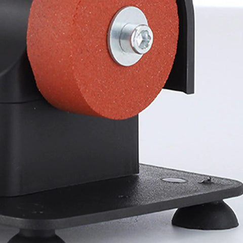 Close-up of red grinding wheel on black housing of the Slick Little Mini Bench Grinder With Dual Grinding Wheels for Razor Sharp Edge Tuning.