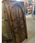 Hand Carved Barn Door With Brown Gold Finish Dope Look And Custom Size For Interior Exterior Use Double Or Single Sliding Or Hinged Front Door Antique And Modern Style Made To Order shows detailed carvings in a workshop setting.