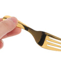 Close-up of a hand holding a gold fork from the Portable Stainless Steel Picnic Cutlery Set With Reusable Forks And Spoons In Pink Case