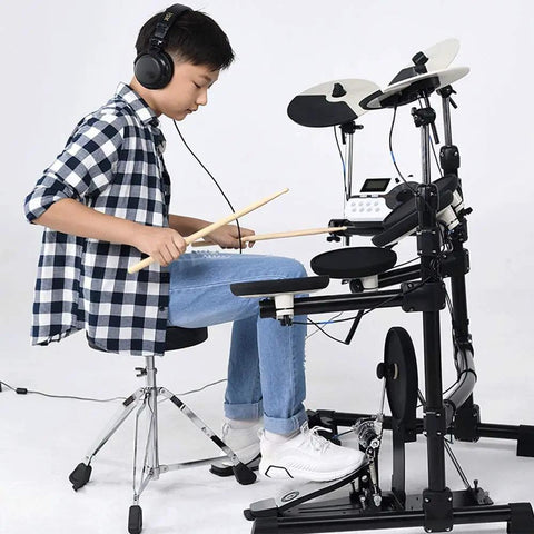 Adjustable Height Drum Stool With Double Brace Frame And Knockout Comfort For Tight Beat Sessions Anti Slip Rubber Feet Versatile Music Throne Built Tough In Sleek Black Finish 55 Cm Wide, shown in use by a young drummer wearing headphones.