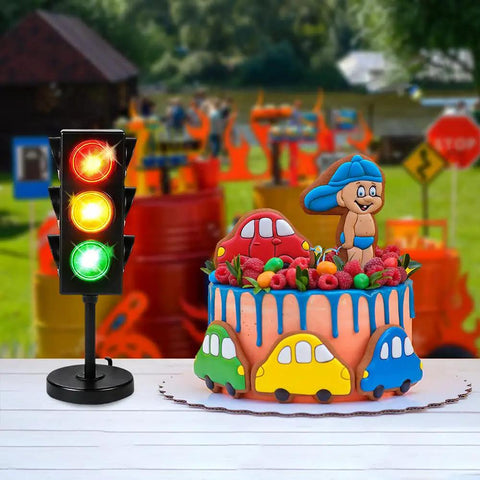 Traffic Light Table Lamp For Kids With Color Changing LEDs next to a colorful car-themed cake in an outdoor setting.