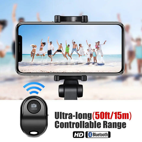 Upgraded Bluetooth 5.0 Remote Shutter For iPhone And Android Cameras next to smartphone showing group jumping on beach