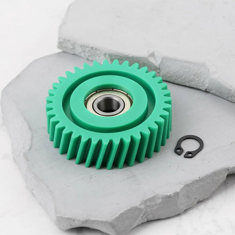 3-Pack Oblique Nylon Motor Gear Set For 500W E-Bike Hub Motor, 35T, 47.5x13mm With 8mm Bearing, Replacement Upgrade For Electric Bicycle Powertrain And Easy Install. Close-up of turquoise gear on concrete surface.