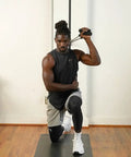 Man using Space Saving Wall Mount Gym Anchor System With 4 Stackable Resistance Bands Adjustable Rail Car for strength training.