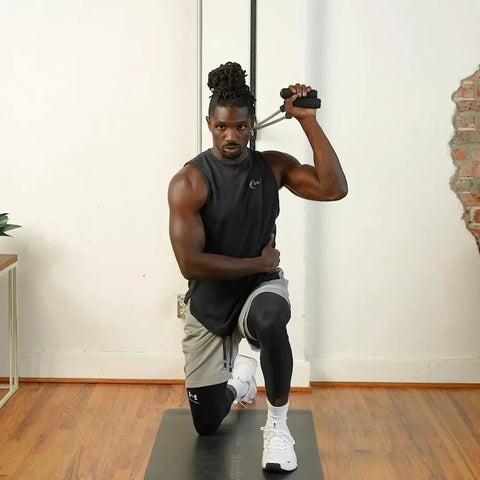 Man using Space Saving Wall Mount Gym Anchor System With 4 Stackable Resistance Bands Adjustable Rail Car for strength training.