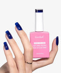 Hand holding bottle of Navy Blue Gel Nail Polish Soak Off 0.5 Fl Oz UV LED Safe For Sensitive Skin HEMA Free TPO Free Non Toxic