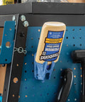 Upside Down Glue Bottle Dock Station With One Handed Access For 4oz 8oz And 16oz Bottles mounted on a pegboard in a workshop.