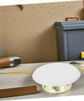 Hella Dope Decorative Fire Sprinkler Covers For Concealed Head Valves on a workbench with metal and wood tools.