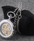 Mens Classic Steampunk Pocket Watch Gold Skeleton Hand Wind Mechanical Timepiece in Box with silver chain displayed on cushion