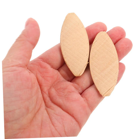 Heavy Duty Maple Wood Joiner Biscuits 100 Piece Pack Smooth Domino Router held in hand for quick furniture glue joints.