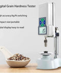 Hella Precise Digital Grain Hardness Tester For Wheat And Rice Crops Smooth Backlit Lcd Display with seeds in a spoon.