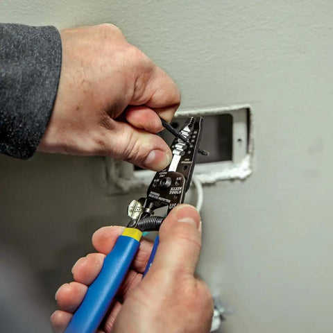 Person using wire stripper from Outlet Repair Tool Kit With GFCI Receptacle Tester, Non Contact Voltage Tester, And Wire Stripper.