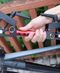 Hand holding adjustable clamp bracket for Portable Bike Repair Stand For On The Go Maintenance, Compact Space Saving Clamp Stand For Mountain And Road Bikes, Durable Lightweight Build