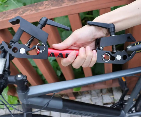 Hand holding adjustable clamp bracket for Portable Bike Repair Stand For On The Go Maintenance, Compact Space Saving Clamp Stand For Mountain And Road Bikes, Durable Lightweight Build