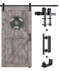 6.8 Foot Sliding Barn Door Hardware Kit With 6.8 Foot Track Kit, Pull Handle Set And Floor Guide For 36 To 40 Inch Doors J Shape Smooth Quiet Operation Easy To Install Black Powder Coated Durable Alloy alongside a wooden barn door.