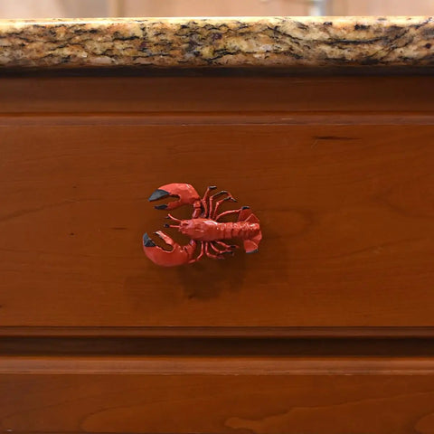 Premium Red Lobster Metal Drawer Pulls Featuring A Slick Distressed Finish For Nautical Cabinet Hardware and Coastal Kitchen Decor on wood drawer.