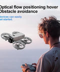 Mini RC Drone With Camera For Easy Night Flying, Durable ABS Body hovering near operator using remote control