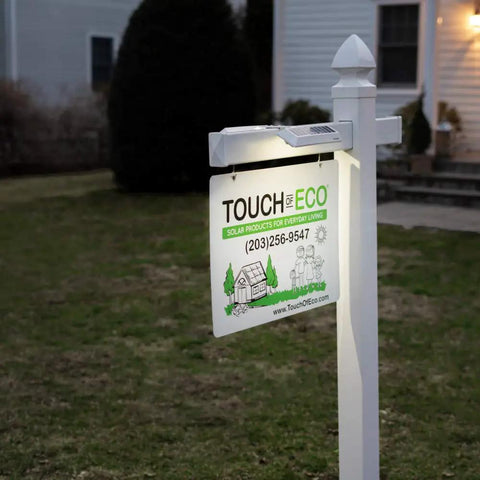 Solar Dual Sided LED Post Light For Real Estate Signs And Business Yards illuminating a yard sign at dusk.