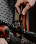 Using No Sweat 89 Piece Gunsmithing Screwdriver Set With Hollow Ground Bits to adjust rifle scope settings.