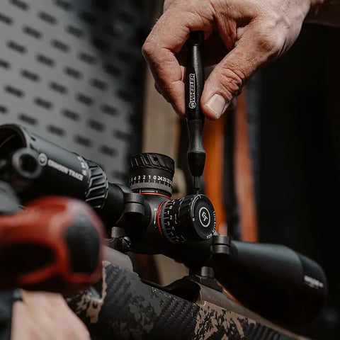Using No Sweat 89 Piece Gunsmithing Screwdriver Set With Hollow Ground Bits to adjust rifle scope settings.