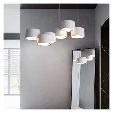 Sleek Six Head Led Pendant Lamp With Rock Solid Iron Frame Smooth Dimming Tech and Cozy Ambient Glow, hanging above a mirror.