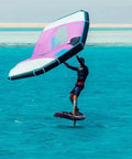 Person using Versatile Kitesurfing Wing For Wind Wing Foiling And Surfing With Two Window Design Surge Wing on turquoise water.