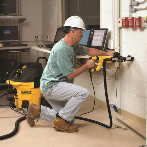 Person using Dust Extractor Telescope With Hose For SDS Rotary Hammers Black Pro Grade Attachment on corded hammer indoors