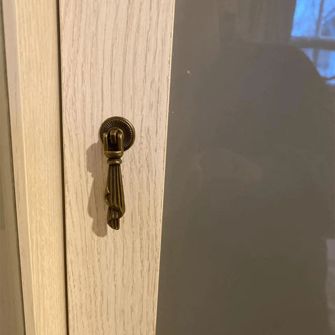 Antique Bronze Metal Drawer Cabinet Pulls 2 Pack With Screws, Single Hole Drop Handles 0.75 X 2.36 Inches, installed on cabinet