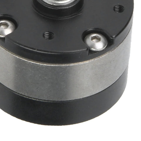Close-up of VGEBY1 gear reducer for RC 540 motor; black top plate, silver housing, mounting screws visible.