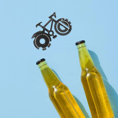 Compact Bicycle Shaped Multitool Keychain For Men Stainless Steel next to beer bottles on blue background