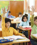 Children in a classroom with 40 Pack Clear Adhesive Desk Nameplate Pockets, 13.5 by 4.7 Inch Self Adhesive Name Tag Sleeves on desks.