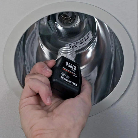 Hand using ET300 Circuit Breaker Finder With Bluetooth 4.2 in a light fixture for locating 120V circuits fast, ideal for DIY projects.