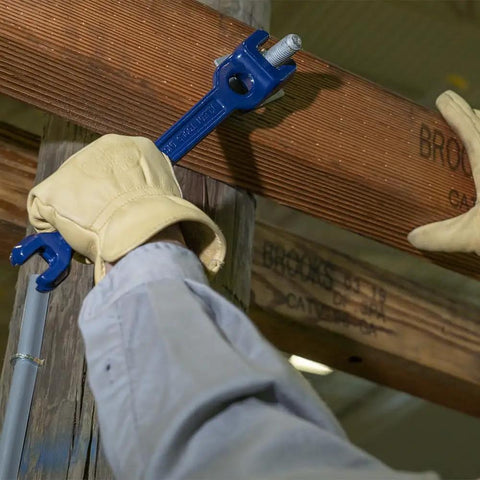 Person using Dual Size Lineman's Wrench With Small Openings Five Eighths And Thirteen Sixteenths Inches And Large Openings Twenty Nine Thirty Second And One Three Thirty Second Inches Forged Bar Steel Heat Treated For Longevity Made In USA on utility pole.