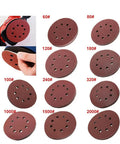 Premium 5 Inch Hook Loop Sanding Discs Featuring Eight Holes For Quick Dust Extraction And Killer Grip For Smooth As Butter Wood Metal Finishing The Real Deal Aluminum Oxide Abrasive Pads displayed in various grits.
