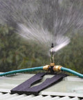 Heavy Duty 360 Degree Rotating Rooftop Sprinkler For Backyard Boss Lawn Cooling And Garden Watering With Smooth Sweep Adjustment And Built Different Zinc Frame spraying water outdoors.