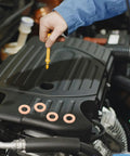 Mechanic using dipstick near 200 Piece Copper Sealing Washers And Flat Ring Gasket Set For Automotive Sheet Metal Repair DIY
