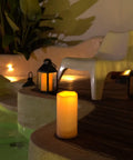 Large 4x10 Waterproof Outdoor Flameless Candles Battery Operated LED Pillar Lights with remote by a pool at night