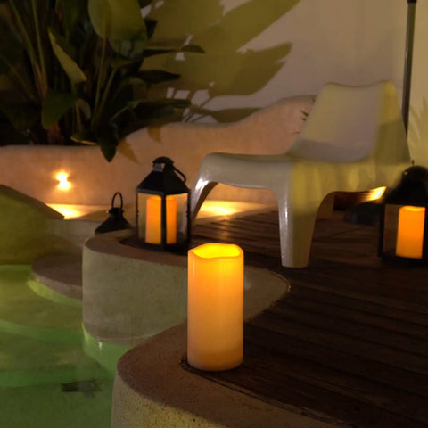 Large 4x10 Waterproof Outdoor Flameless Candles Battery Operated LED Pillar Lights with remote by a pool at night
