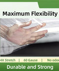 Hand holding Heavy Duty Stretch Wrap Roll 11.8 Inch By 500 Feet Clear Plastic Moving Film showing flexibility and durability.