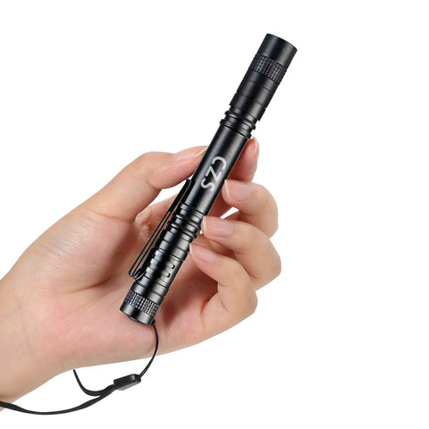 Hand holding a 1000 Lumen LED Pen Light Flashlight Pocket Torch, ultra compact aluminum alloy handheld EDC, black with strap.