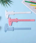Three Pack Handy Vernier Caliper Set 6 Inch 150mm Dual Scale Inch And Metric Precision Measuring Tools in white, pink, and blue on table