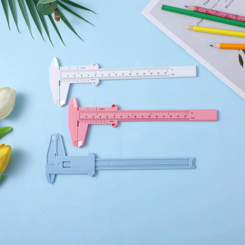Three Pack Handy Vernier Caliper Set 6 Inch 150mm Dual Scale Inch And Metric Precision Measuring Tools in white, pink, and blue on table