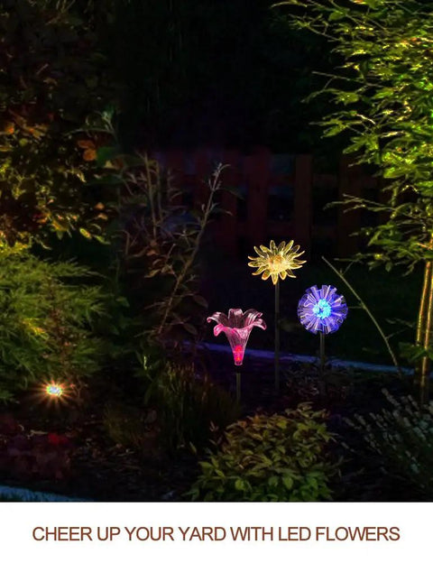 Solar Stake Lights With Color Changing LEDs And Life Size Figurines illuminate a garden at night with multicolor glow.