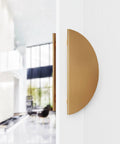 Side view of Half Round Pull Handle Double Sided Heavy Duty Aluminum Push Pull Handle in gold finish on a wooden door.