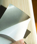 Close-up of 2 Pack 200x300mm Ferrite Shielding Sheets for RFID and NFC Protection, EMI absorber sticker being peeled, customizable thickness