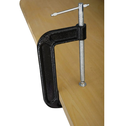 Heavy Duty 4 Pack 6 Inch C Clamp Set With 6 Inch Jaw Opening And 2 And 5 Eighths Inch Throat For Woodworking Welding And Building Projects Rust Resistant Cast Malleable Iron With Black Coated Finish attached to a table edge.