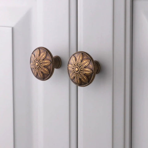 Antique Brass Cabinet Knobs Set Of 4 1.4 Inch Round Vintage Dresser Drawer Handles For Cabinets And Furniture Rustic Flower Shaped Design Durable Zinc Alloy Finish on white cabinet